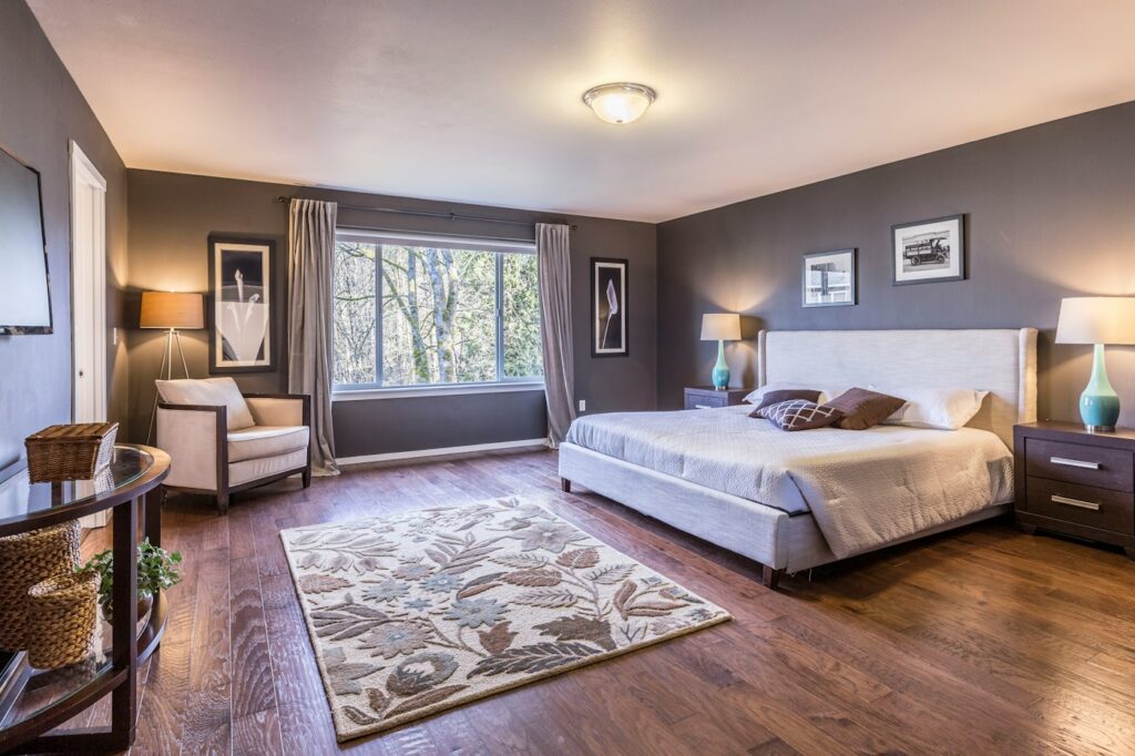 Bedroom interior with warm timber flooring — photo by Francesca Tosolini