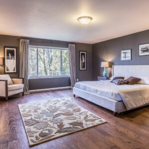 Bedroom interior with warm timber flooring — photo by Francesca Tosolini
