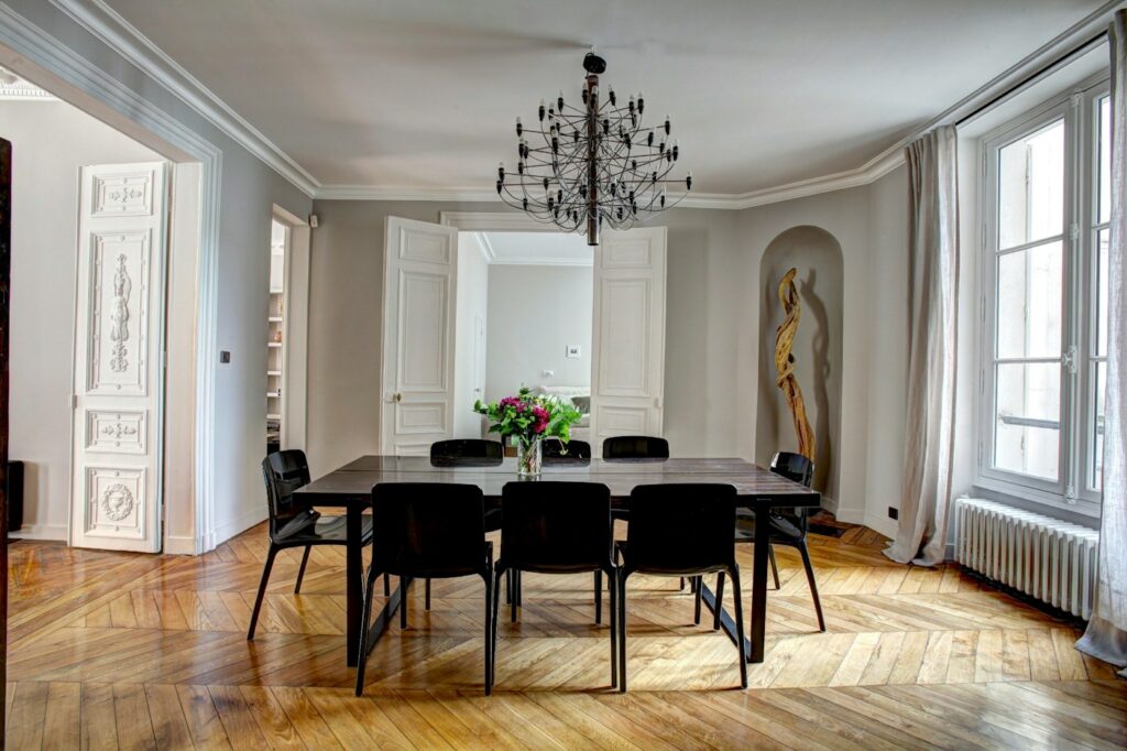 Dining room with timber flooring — photo by Yann Maignan