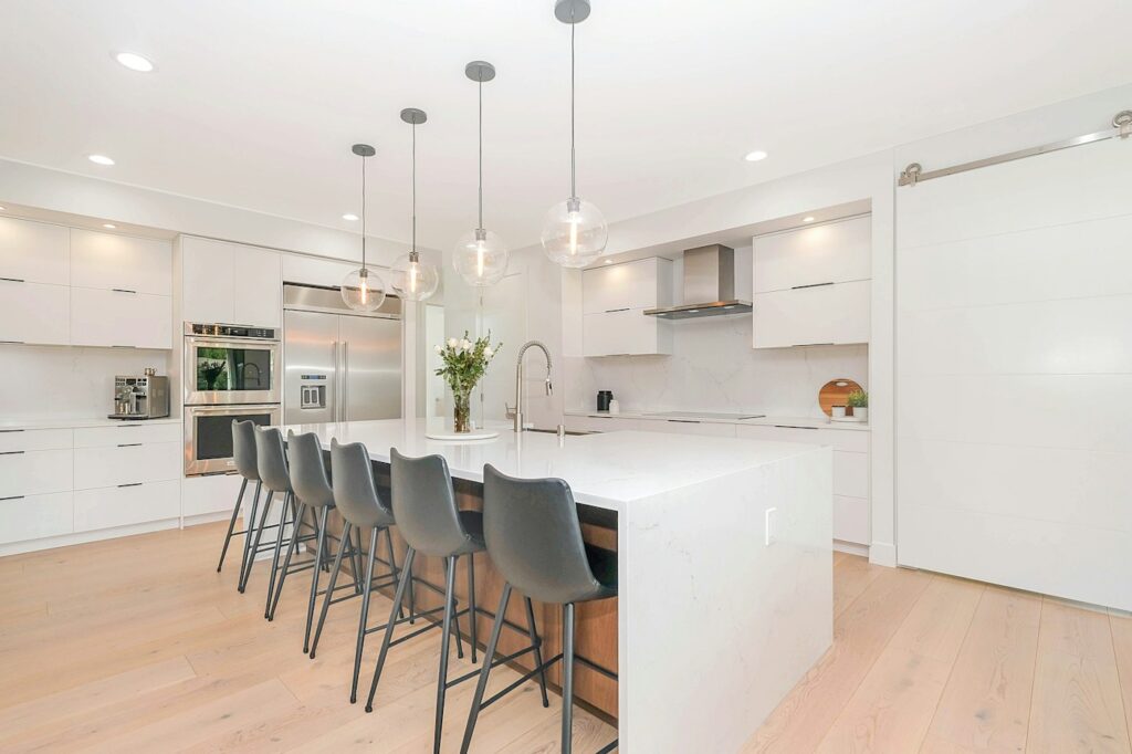 Modern luxury kitchen with timber flooring — photo by Zac Gudakov