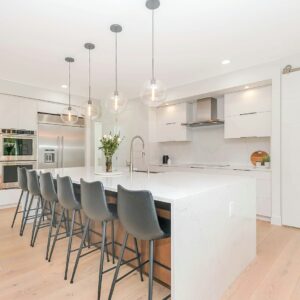 Modern luxury kitchen with timber flooring — photo by Zac Gudakov